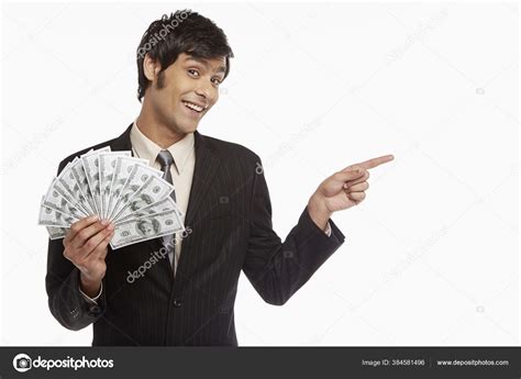 Businessman Holding Money Pointing Left — Stock Photo © image_hit ...