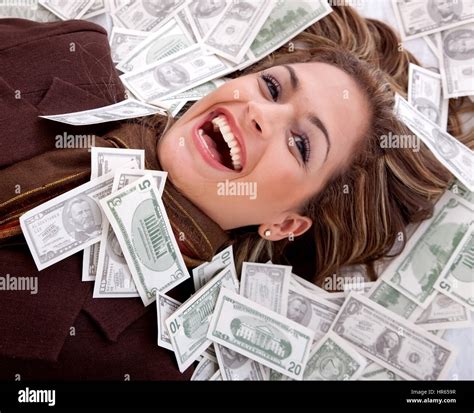 Business woman millionaire with money around her face Stock Photo - Alamy