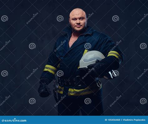 Firefighter In Uniform Over Dark Grey Background. Stock Photo - Image ...