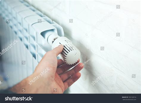 Man Hand Adjusting Temperature By Thermostat Stock Photo 769150516