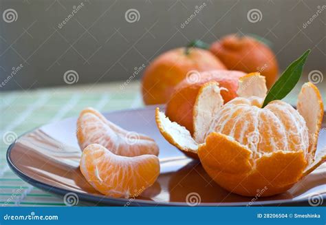 Tangerine On Brown Plate With Peel And Segments Stock Photo Image Of