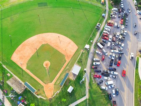 Aerial view a large baseball stadium, full cars at outdoor parking lots ...