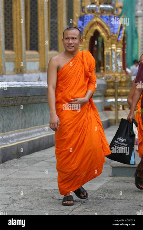 A Buddhist Monk In Bright Orange Robes Tours The Spectacular Grand