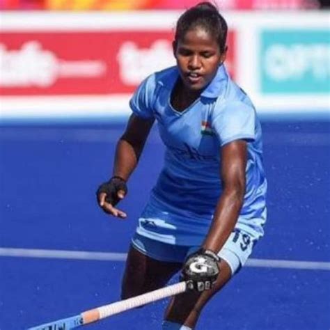 A Female Field Hockey Player In Action On The Field