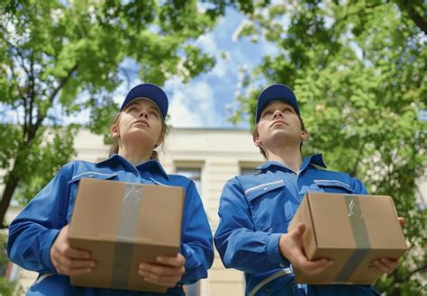 Two Female Workers Holding Boxes With The Word Quot Were On Them Quot