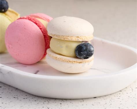 Premium Photo | Baked macarons with different flavors on the table dessert