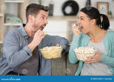 Young Couple Watching Tv And Eating Pop Corn Stock Image Image Of