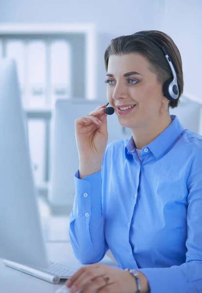 Serious Pretty Young Woman Working As Support Phone Operator With