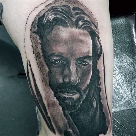 Religious style black and white thigh tattoo of Jesus portrait - Tattooimages.biz