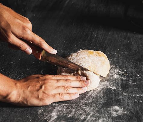 Free Photo | Close-up person cutting dough on black table