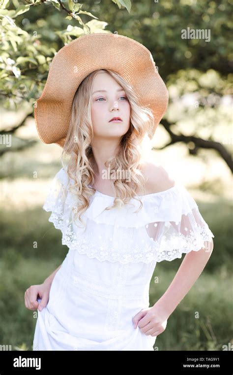 Beautiful Blonde Girl Year Old Wearing White Stylish Dress And Hat Walking In Park