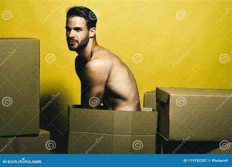 Guy With Naked Torso Sits Among Boxes Delivery And Moving Concept Stock Image Image Of Muscle