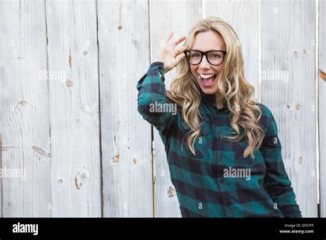 Excited Blonde With Hand On Her Glasses Posing Stock Photo Alamy