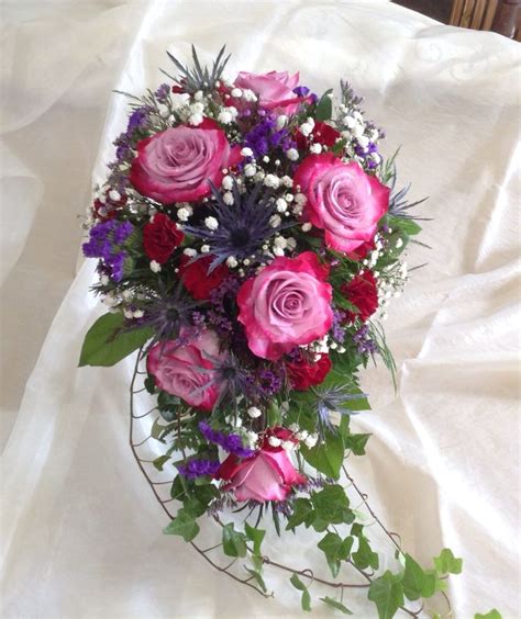 Cascade Bouquet Of Purple Rosessurrounded With Accent Flowers