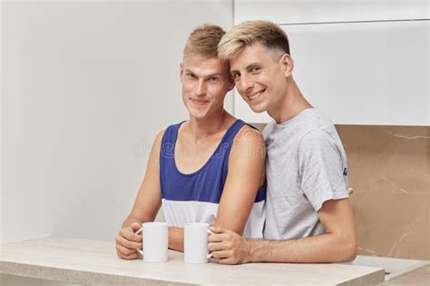 Cute Gay Couple Drinking Coffee In The Morning They Look At The Camera Stock Image Image Of