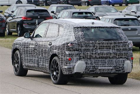 Bmw X X M Spied In Detail Hybrid Hides Strange Exhaust