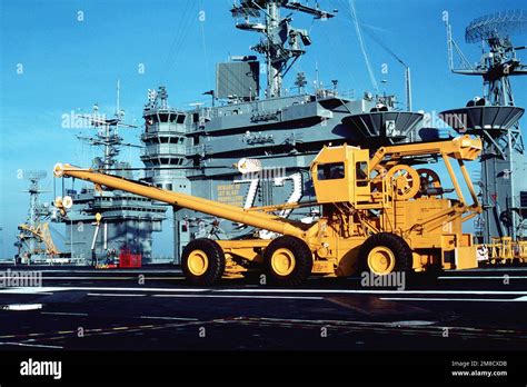 A Crash And Recovery Crane Is Parked On The Flight Deck Of The Nuclear