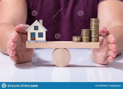 House Model And Money Coins Balancing On A Seesaw Stock Image Image