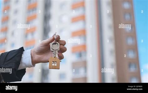 Girl holding keys to apartment against the backdrop of an apartment ...