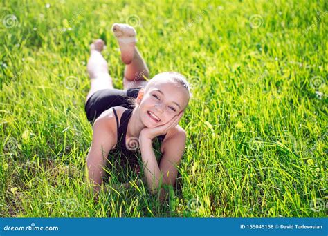 Cute Happy Little Girl Lying On The Grass Stock Photo Image Of