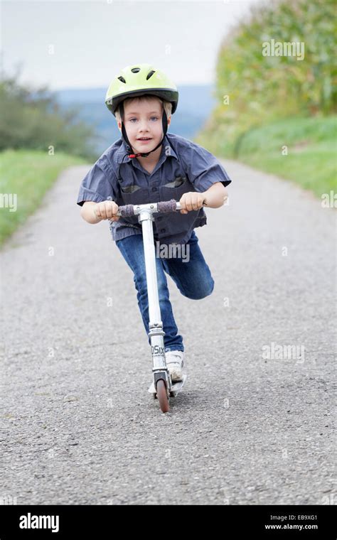 Boy helmet scooter hi-res stock photography and images - Alamy