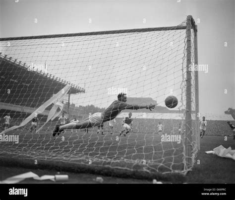 Manchester united goalkeeper harry gregg dives across the goal line hi ...