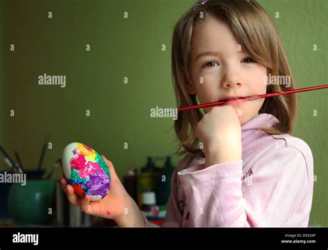 A Happy Young German Girl Painting Eggs At Home For Easter Leipzig