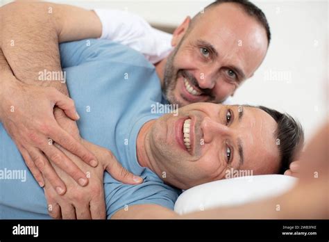 Gay Couple Cuddling In Bed Stock Photo Alamy