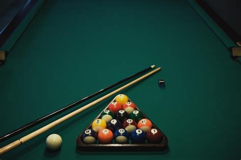 Premium Photo Billiard Balls Cue And Pyramid On Green Table