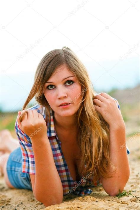 Blonde Woman With Large Breasts Plaid Shirt And Jeans In The San Stock