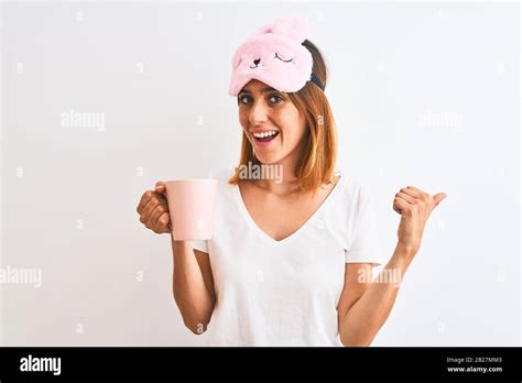 Beautiful Redhead Woman Wearing Sleeping Mask Drinking A Cup Of Coffee