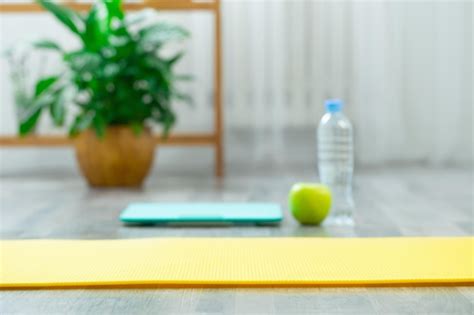 Premium Photo | Fitness mat on wooden floor concept of health and sport