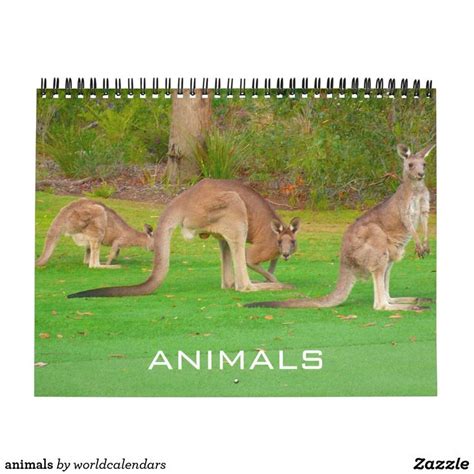 a calendar with an image of kangaroos in the grass and trees behind it that says animals