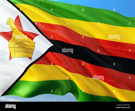 Flag Of Zimbabwe Waving In The Wind Against Deep Blue Sky High Quality