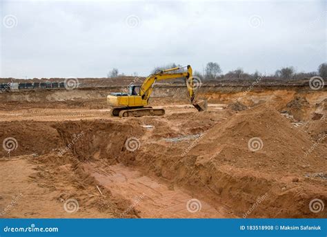 Excavator During Earthworks At Construction Site Backhoe Digging The