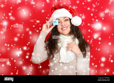 Girl In Santa Hat Portrait With Little T Box Posing On Red Color