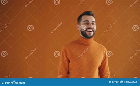 Portrait Of Good Looking Guy Looking Around Then Winking At Camera