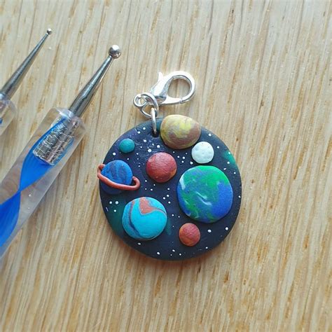 An Galaxy Coin Charm With Some Of The Planets And The Earth S Moon