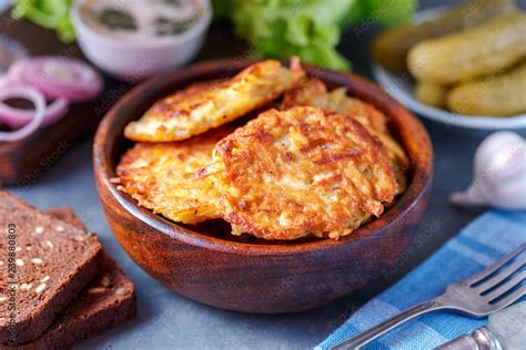 Draniki Potato Fritters Potato Pancakes Lie On A Plate The National