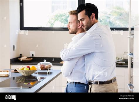 Gay Couple With Eyes Closed Hugging Stock Photo Alamy