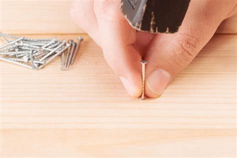 Trabajador Con Un Martillo Y Un Clavo Martillando Un Clavo En Una Tabla