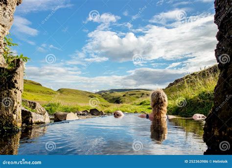 Woman Relaxing And Bathing In Natural Geothermal Heated Hot Pool Hot Spring In Iceland In