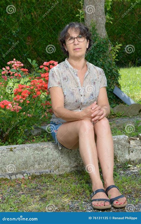 Mature Woman Sitting In Garden Stock Image Image Of Garden Happiness 76131135