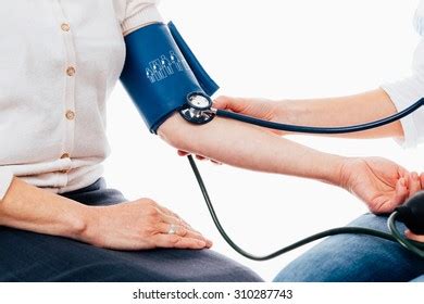 Doctor Checking Pulse Senior Patient Using Stock Photo 310287743