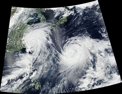 Twin Typhoons Continued To Churn Across The Western Pacific Ocean