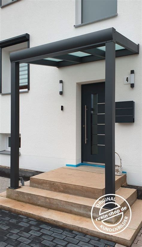 A Black Door And Some Steps In Front Of A White Building