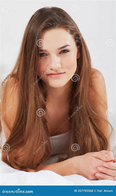 Fresh Faced Beauty Portrait Of An Attractive Young Woman Lying In Bed