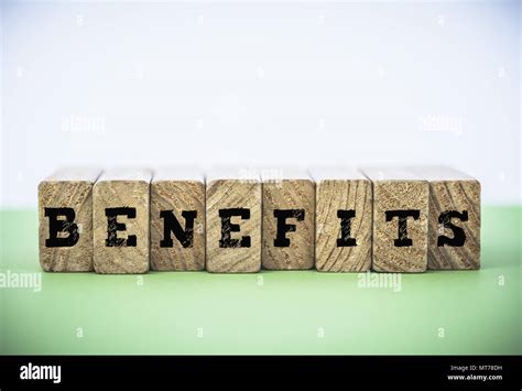 Benefits Word Made From Building Blocks On Green And White Background