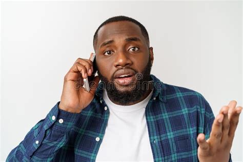 A Young African American Man Talking on His Cellular Phone with a ... 