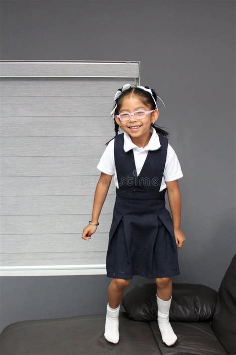 Year Old Latina Brunette Girl With Eye Glasses Dressed In Uniform Plays And Rests In Her